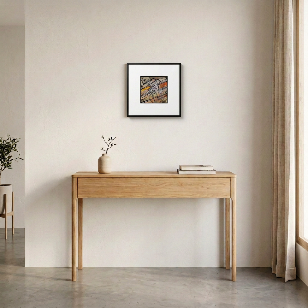 Mise en situation de l’œuvre I dans un cadre noir avec un large passe-partout blanc, au-dessus d’une console contemporaine en bois clair.
